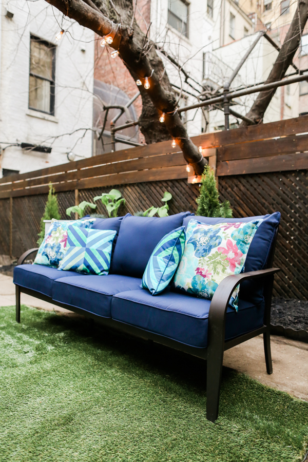 DIY Urban Patio Makeover Entertaining Seating Outdoor Pillows Faux Grass